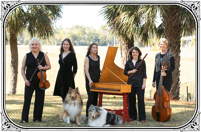 A photograph of Savannah Baroque members standing outdoors in a garden with their instruments. Photograph by Elizabeth Osterberger.